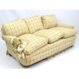 A large three seat sofa with horse hair upholstery and feather cushions.