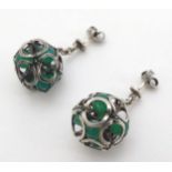 A pair of white metal drop earrings set with green stone small spheres.