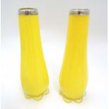 A pair of yellow glass vases with silver collars hallmarked London 1924 maker Henry Williamson Ltd.