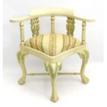 A 20thC corner chair with carved cabriole legs terminating in ball and claw feet,