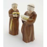 A pair of Royal Worcester candle snuffers in the form of monks, makers mark to interior,