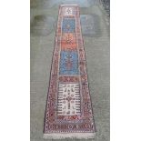 Rug / Carpet : A long Turkish woollen runner, with 5 distinct central sections in salmon pink,