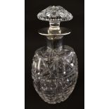 A cut glass decanter with silver collar hallmarked Sheffield 1956 maker Cooper Brothers & Sons Ltd.
