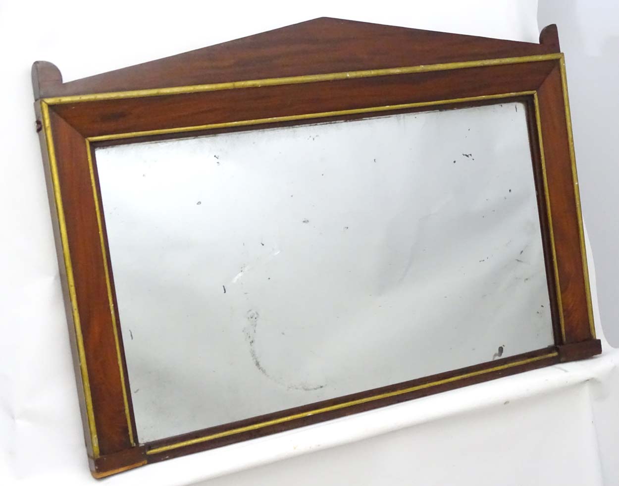 A Regency mahogany and gilt over mantle mirror.