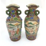A pair of Oriental style vases decorated with two panels of Japanese women in a pagoda garden