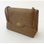 A pale brown lizard handbag with gilt coloured hardware and feet,