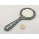 A c.1900 hand mirror with micro mosaic decoration and bevelled glass.