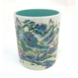 A Chinese famille rose brush pot painted in enamels depicting a continuous landscape scene of
