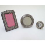 A small photograph frame of circular form with engraved croc skin effect decoration hallmarked