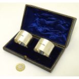 A cased pair of silver napkin rings hallmarked Sheffield 1944 maker James Dixon & Sons.