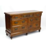 An Edwardian sideboard with fluted pilaster decoration and carved floral decoration to the drawers