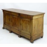 An 18thC sycamore sideboard with three short drawers above three cupboards.