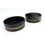 A pair of Regency ebonised and gilt table coasters 5 1/4" diameter x 1 3.