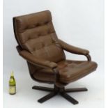Vintage Retro: a Danish brown leather open arm swivel lounge chair CONDITION:
