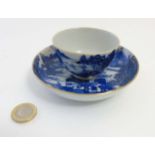 A blue and white Caughley like small tea bowl and saucer, depicting an oriental pagoda landscape ,