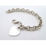 A silver bracelet with heart fob marked 'Tiffany & Co. 925.