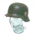 Militaria : A WWII German M1942 Stalhelm helmet , having green overpainted finish ,