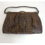 An early 20thC vintage ladies large crocodile skin handbag with head and foot decoration,