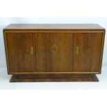 A French Art Deco walnut sideboard with brass mount and handles,