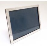 A silver photograph frame of rectangular landscape from with easel / strut back hallmarked