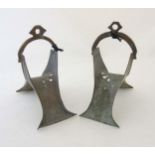 19thC Dogon African / Mali stirrups of bronze construction with punch and wrigglework decoration .