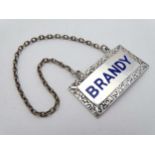 A silver wine label / decanter label with blue enamel script ' BRANDY ' hallmarked Birmingham 1951