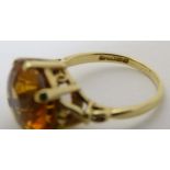 A mid 20thC 18ct gold ring set with facet cut citrine.
