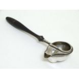 An American silver plate feeder or formerly a dripless strainer spoon, with ebonised handle.