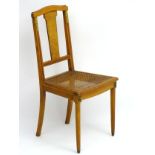 An early Louis XVI style French walnut and ormolu cane seated chair 37" high CONDITION: