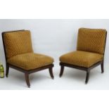 A pair of Regency style Lounge Chairs standing on sabre legs with Neoclassical carving and