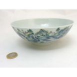 A Chinese Famille Rose iridescent landscape bowl decorated with a continuous oriental landscape