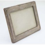 A photograph frame with silver surround hallmarked Birmingham 1920 maker A J Zimmerman.