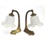 Early 20thC organic table lamps : a pair of brass and original flower head shaped glass tiltable