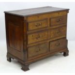 An 18thC oak hinged lidded chest of drawers,