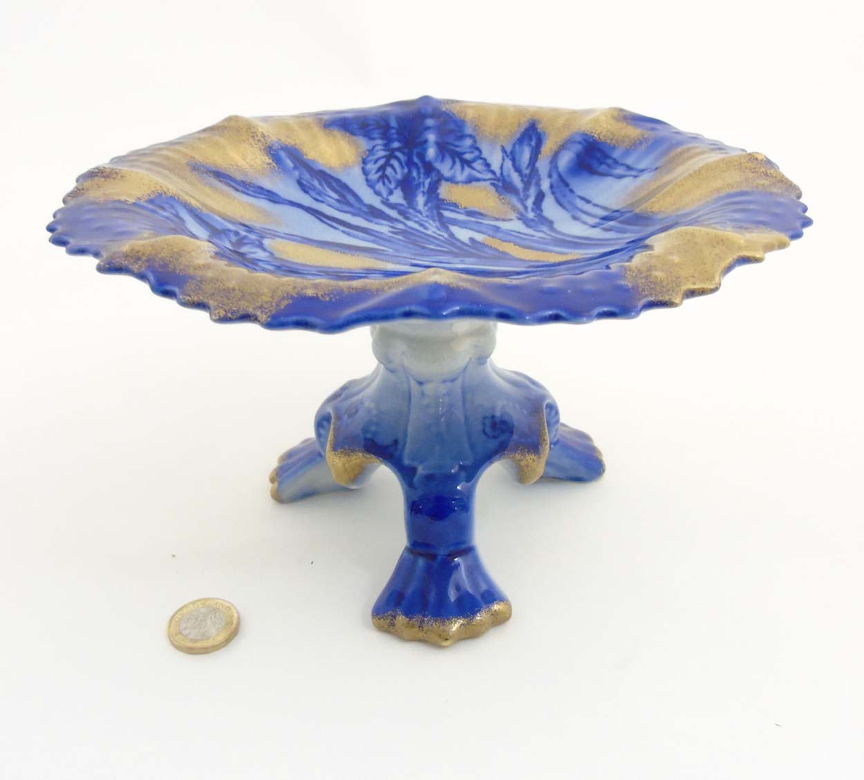 A Victorian Flow Blue Ironstone three footed Staffordshire tazza depicting flowers to plate with