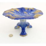 A Victorian Flow Blue Ironstone three footed Staffordshire tazza depicting flowers to plate with