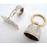 A Sterling silver food pusher together with a Continental white metal rattle marked .800.