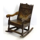 An early / mid 19thC oak wainscot rocking chair,
