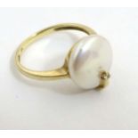 A 9ct gold ring set with pearl button and white stone CONDITION: Please Note - we