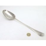 A Geo III silver stuffing spoon hallmarked London 1756 maker Ebenezer Coker with engraved armorial.