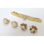 A 9ct gold bar brooch set with central opal together with a pair of 9 ct gold opal earrings and 9ct