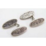 A pair of hallmarked silver cufflinks with engraved decoration CONDITION: Please