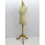 An early 20thC dress maker's mannequin, fully adjustable and standing on a tripod base.