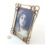 A late Victorian brass chain link photograph frame with easel / strut back.
