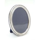 A silver photograph frame of oval form hallmarked Sheffield 1996 maker Carrs.