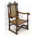 A 17thC oak armchair with caned backrest and seat,