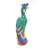 A Chinese porcelain figure of a phoenix / Fenghuang , painted in greens, yellows, reds,