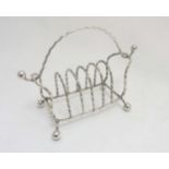 Arts and Crafts : A 19thC Aesthetic movement silver plate 6-division toast rack with handle.