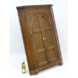 A late 18thC corner cupboard with marquetry inlay to the frieze with boxwood stringing,