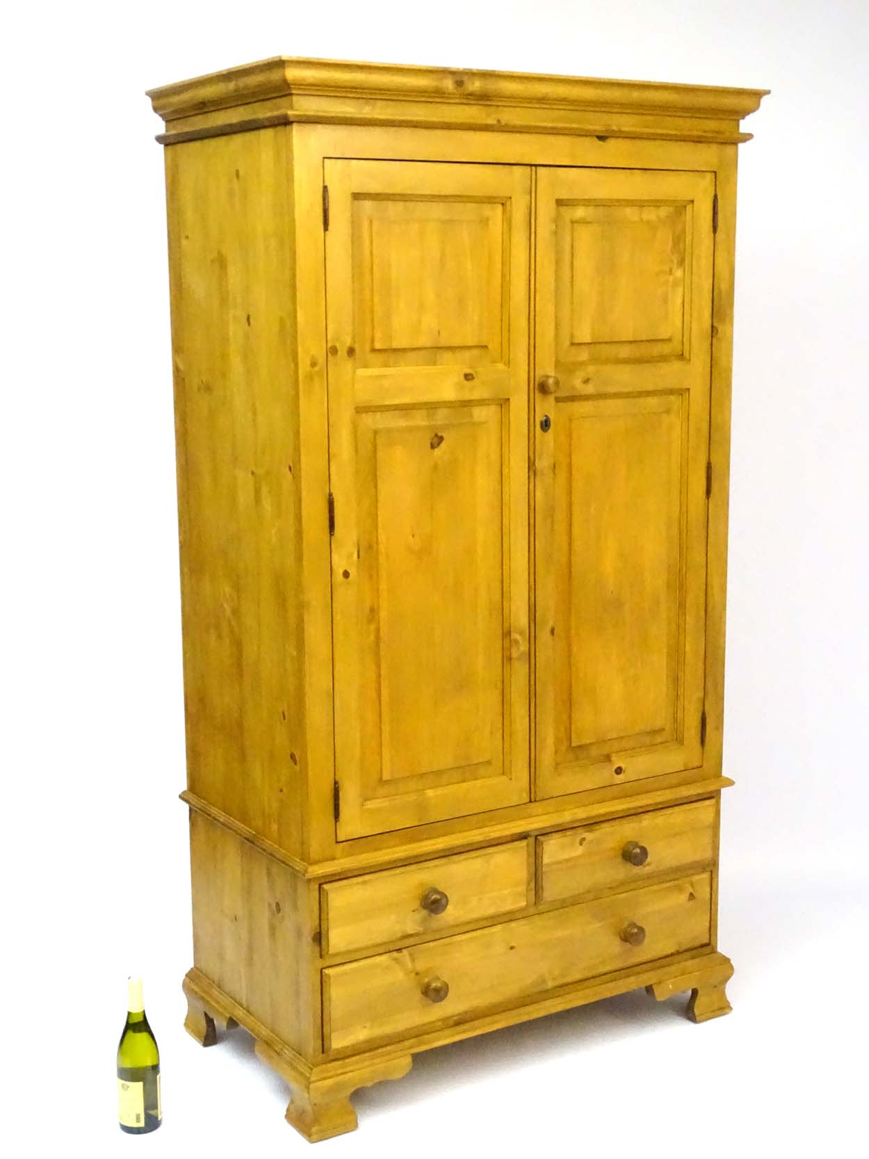 A mid / late 20thC pine wardrobe with an ovolo moulded top above two doors containing storage space - Image 9 of 9